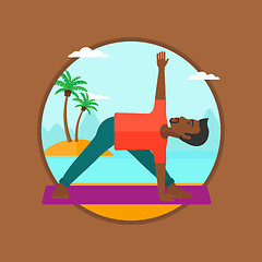 Image showing Man practicing yoga triangle pose on the beach.