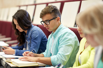 Image showing group of students with books writing at lecture