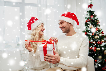 Image showing happy couple at home with christmas gift box