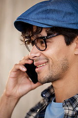 Image showing close up of hipster man calling on smartphone