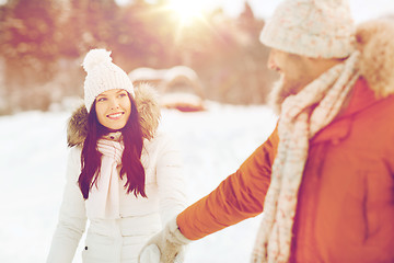 Image showing happy couple walking along snowy winter field