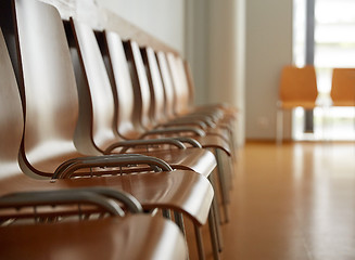 Image showing wooden chairs at hospital waiting room