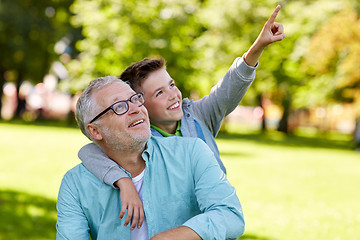 Image showing grandfather and boy pointing finger at summer park