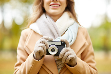 Image showing close up of woman with camera in autumn park