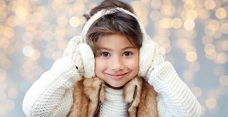 Image showing happy little girl wearing earmuffs