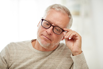 Image showing close up of senior man in glasses thinking