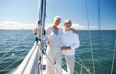 Image showing senior couple hugging on sail boat or yacht in sea