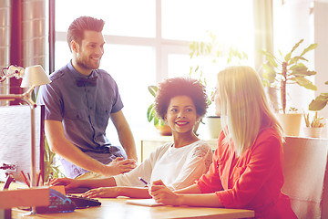 Image showing happy creative team talking in office