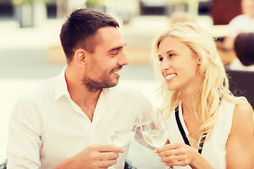 Image showing happy couple clinking glasses at restaurant lounge