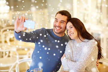 Image showing couple taking smartphone selfie at cafe restaurant