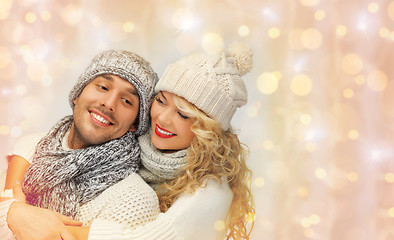 Image showing happy family couple in winter clothes hugging