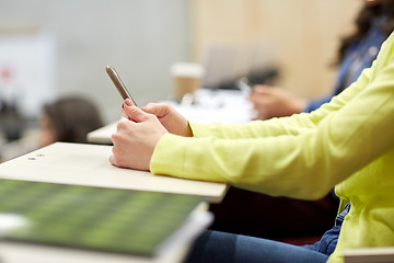 Image showing close up of student with smartphones on lecture