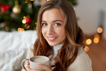 Image showing happy woman drinking cocoa at home for christmas