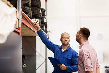 Image showing auto mechanic with clipboard and man at car shop