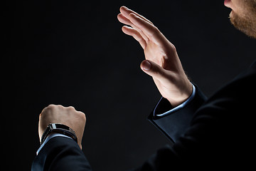 Image showing close up of businessman hands with smart watch