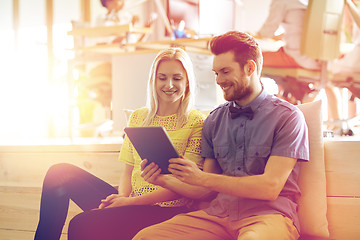 Image showing happy creative team with tablet pc in office