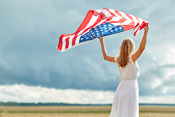 Image showing happy woman with american flag on cereal field