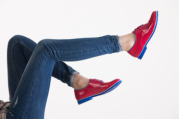 Image showing Woman\'s Legs In Blue Jeans And Red Shoes