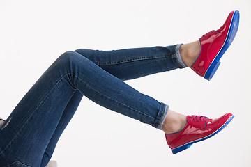 Image showing Woman\'s Legs In Blue Jeans And Red Shoes
