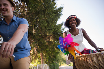 Image showing Young multiethnic couple having a bike ride in nature