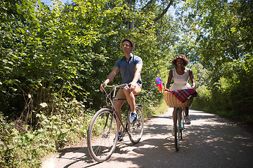 Image showing Young multiethnic couple having a bike ride in nature