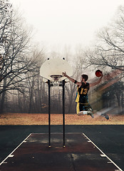 Image showing Full length portrait of a basketball player with ball