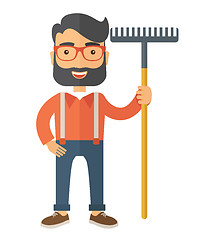 Image showing Man with a mustache holding rake.