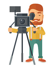Image showing Videographer and his video cam with tripod.