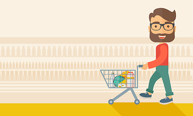 Image showing Male Shopper Pushing a Shopping Cart.