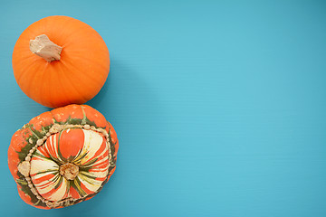 Image showing Ripe pumpkin and Turks turban squash on turquoise background