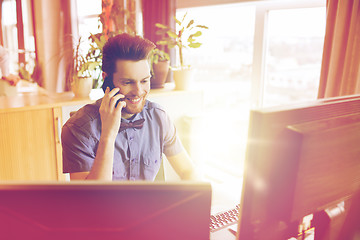 Image showing happy creative male worker calling on smarphone