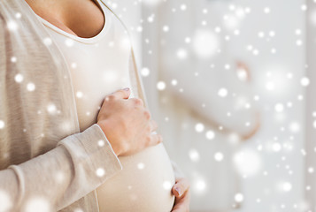 Image showing close up of pregnant woman belly and hands