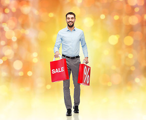 Image showing smiling man with red shopping bag