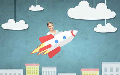 Image showing teen girl flying on rocket above cartoon city