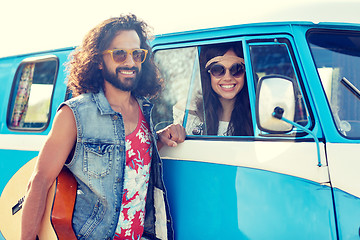 Image showing smiling young hippie friends over minivan car