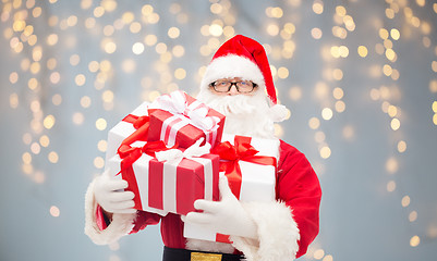 Image showing man in costume of santa claus with gift boxes