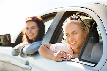 Image showing happy teenage girls or women in car at seaside