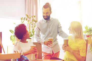 Image showing happy creative team drinking coffee in office