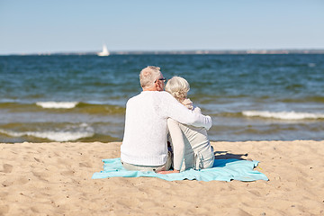 Image showing happy senior couple hugging on summer beach