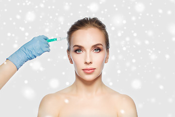 Image showing woman face and hand with syringe making injection