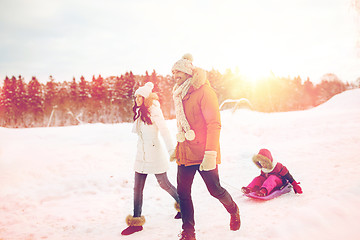 Image showing happy family with sled walking in winter outdoors