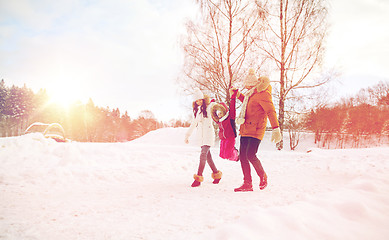 Image showing happy family in winter clothes walking outdoors