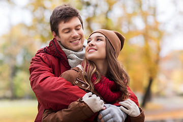 Image showing happy young couple hugging in autumn park