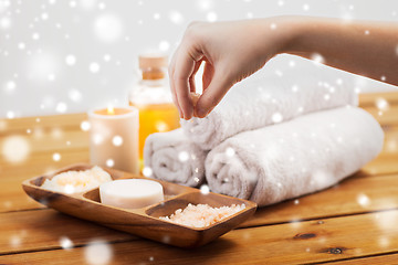 Image showing hand with pink salt and bath stuff