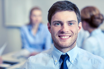Image showing smiling businessman face in office