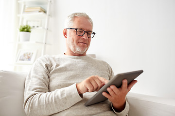 Image showing senior man with tablet pc at home