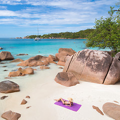 Image showing Woman sunbathing at Anse Lazio picture perfect beach on Praslin Island, Seychelles.