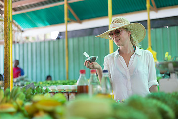 Image showing Traveler shopping on traditional Victoria food market, Seychelles.