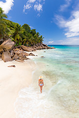 Image showing Woman enjoying Anse Patates picture perfect beach on La Digue Island, Seychelles.