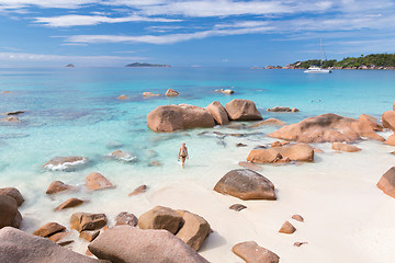 Image showing Woman enjoying Anse Lazio picture perfect beach on Praslin Island, Seychelles.